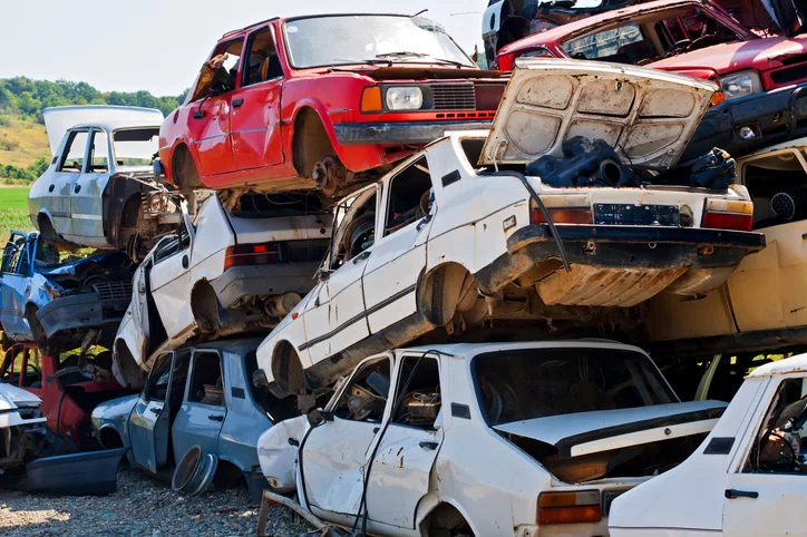 Stacked scrap and junk cars at an auto recycling yard